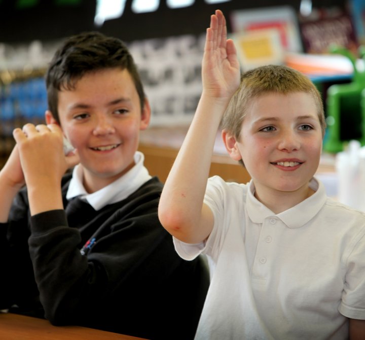 Child raising hand in class