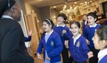 School children in uniform looking excited
