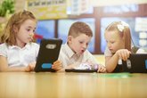 Boy and girl with technology tablet reading