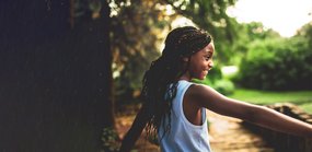Child girl outside happy nature community - National Literacy Trust