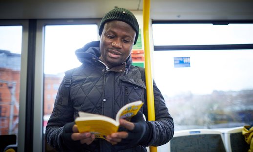 Adult reading on train