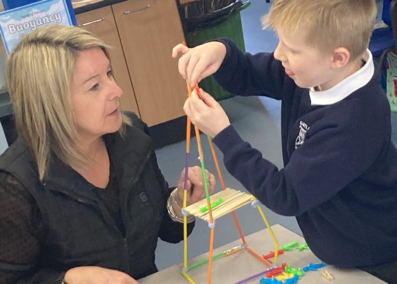 A volunteer supports a pupil in our Dream Big Engineering classroom programme