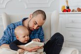 Dad reads with his baby making sounds