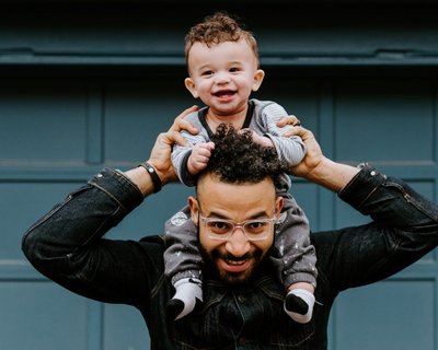 Early Words Matter Dad with baby smiling on his shoulders