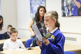 Girl reading football magazine.jpg