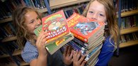 Girls with pile of books.JPG