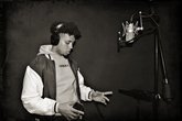 Inside Stories programme  - A young adult performs into a microphone