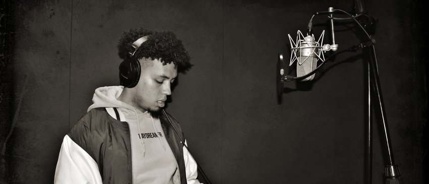 Young adult performing into a microphone