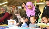 Mother_and_kids_looking_at_books.jpg