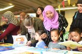 Mother_and_kids_looking_at_books.jpg