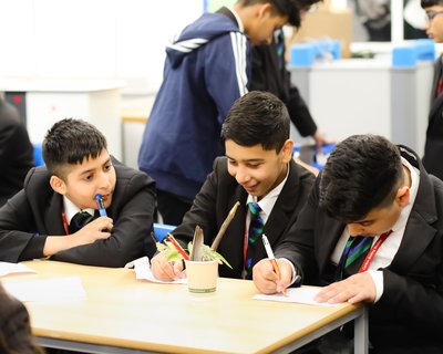 Secondary boys writing in classroom