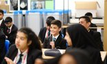 Secondary school classroom - pupils laughing while sat at desks