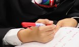 Close up of a student writing during a National Literacy Trust poetry workshop