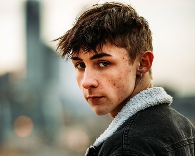 Teenage boy looks at camera