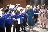 Her Majesty Queen Camilla greeting Moreland Primary School pupils who are waving flags decorated with their favourite book characters. (Credit: WeShootLondon)