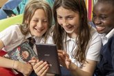 Children reading humorous book