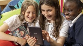 Children reading humorous book