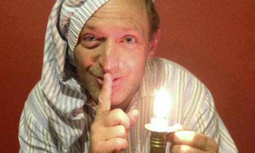 Rogan Mills storyteller in nightgown with candle