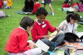 Children outside chatting about a book