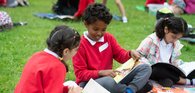 Children outside chatting about a book