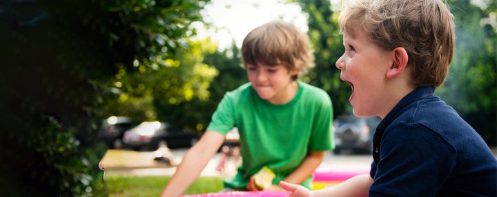 Two younger children boys playing outside