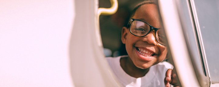 Young child girl big smile close up face early years_National Literacy Trust