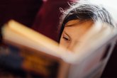 Close up of a young child reading a book