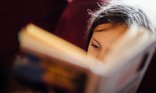 Close up of a young child reading a book