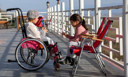 children talking one in wheelchair.jpg