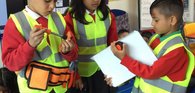 Three 6–7-year-olds from an East London school exploring the world of work by dressing up as engineers.