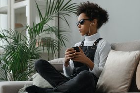 Teen listening with headphones